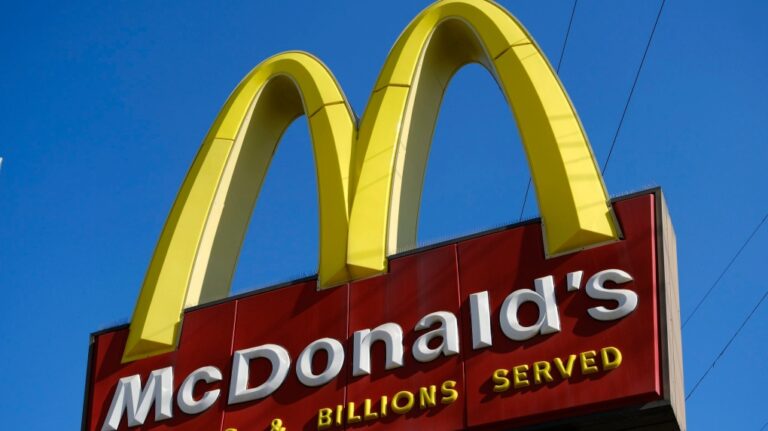 A McDonald's sign is seen above one of the fast food chain's locations in downtown Los Angeles. (AP Photo/Richard Vogel)