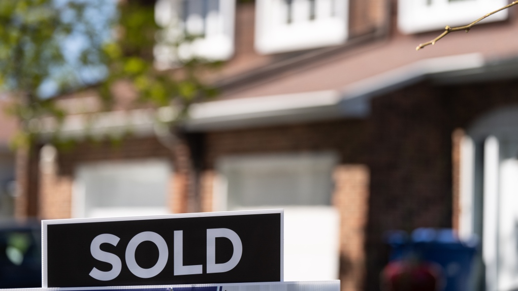 A real estate sign is posted outside a home in Pointe-Claire, a city in Montreal's West Island, Tuesday, May 7, 2024. THE CANADIAN PRESS/Christinne Muschi