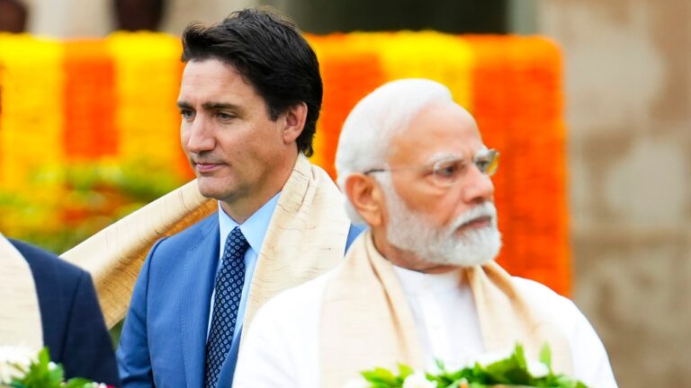 Canada's Prime Minister Justin Trudeau, left, walks past Indian Prime Minister Narendra Modi as they take part in a wreath-laying ceremony at Raj Ghat, Mahatma Gandhi's cremation site, during the G20 Summit in New Delhi, Sunday, Sept. 10, 2023. (Sean Kilpatrick/The Canadian Press)