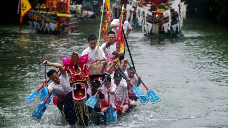 Participants paddle their dragon boat as they parade in Xixi Wetland to mark the Dragon Boat Festival in Hangzhou in east China's Zhejiang province, Monday, June 10, 2024. (Chinatopix via AP)