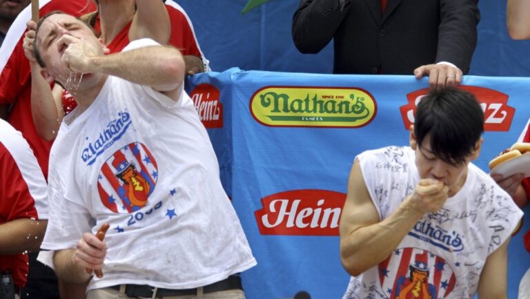 Joey Chestnut, defending champion of the Nathan’s Famous Fourth of July hot dog eating contest, left, works to outpace former champion Takeru Kobayashi, right, July 4, 2009, in New York. (Craig Ruttle/AP Photo)
