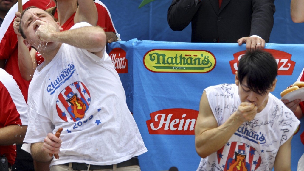 Joey Chestnut, defending champion of the Nathan’s Famous Fourth of July hot dog eating contest, left, works to outpace former champion Takeru Kobayashi, right, July 4, 2009, in New York. (Craig Ruttle/AP Photo)