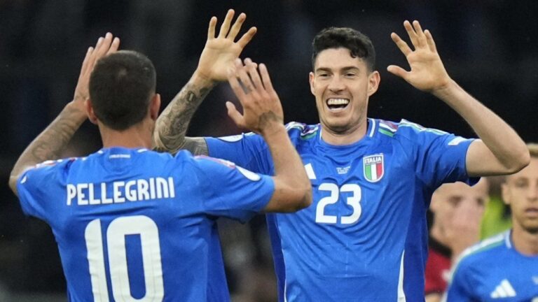 Italy's Alessandro Baston celebrates with his teammate Lorenzo Pellegrini after scoring his side's opening goal during a game between Italy and Albania at the Euro 2024. (Alessandra Tarantino/AP Photo)