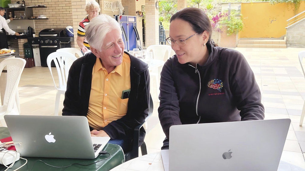 Dr. Francisco Lopera, left, of the University of Antioquia, confers with fellow researcher Yakeel Quiroz of Massachusetts General Hospital. (Massachusetts General Hospital)