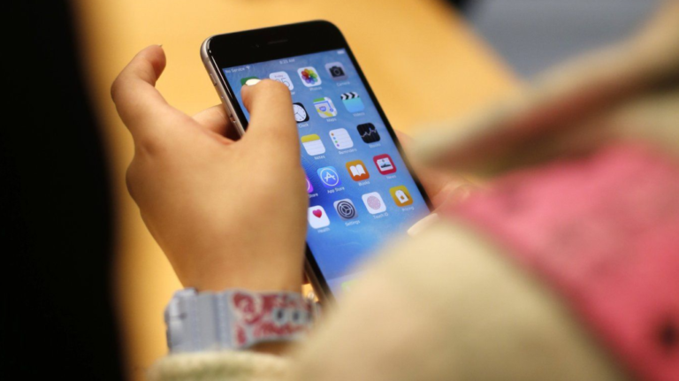 A child holds an iPhone at an Apple store on Sept. 25, 2015 in Chicago. (AP Photo/Kiichiro Sato)