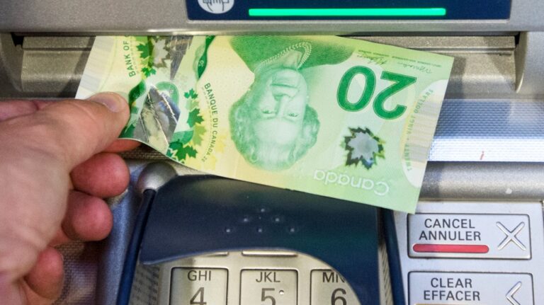 Money is removed from an ATM in Montreal, Monday, May 30, 2016. (Ryan Remiorz / The Canadian Press)
