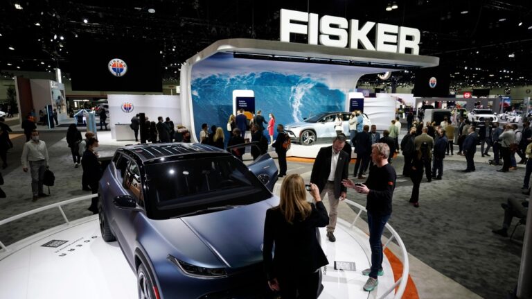 FILE - Henrik Fisker, Chairman & CEO at Fisker Inc. at right, shows his company's new EV, the Ocean, at the AutoMobility LA Auto Show Nov. 17, 2021, in Los Angeles. Fisker filed for Chapter 11 bankruptcy protection, Monday, June 17, 2024, the second electric startup to do so in the last year as even industry leaders struggle to lure more buyers beyond the early adapters of the technology.  (AP Photo/Marcio Jose Sanchez, File)