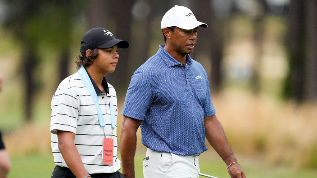 Tiger Woods walks with his son Charlie on the 11th hole during a practice round for the U.S. Open golf tournament, June 10, 2024, in Pinehurst, N.C. (AP Photo/Matt York)