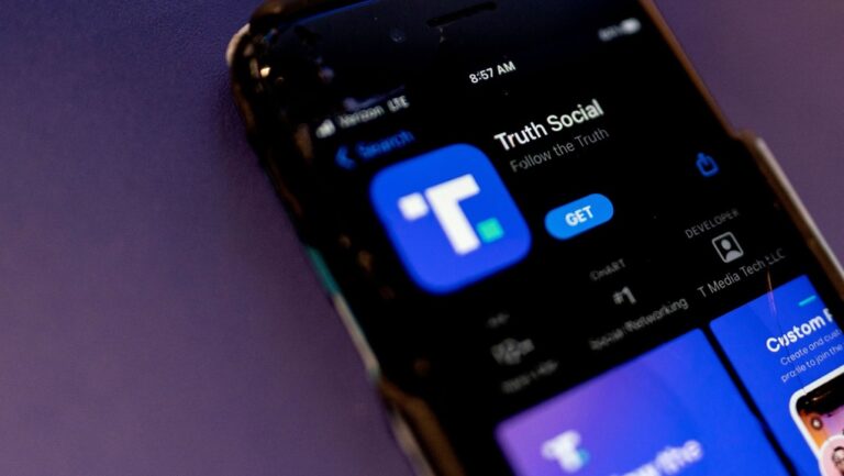 A phone screen displays the Truth Social app in Washington, DC, in February 2022. (Stefani Reynolds / AFP)
