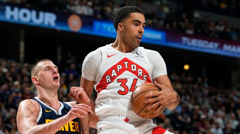 Toronto Raptors center Jontay Porter, right, pulls in a rebound as Denver Nuggets center Nikola Jokic, left, defends in the first half of an NBA basketball game Monday, March 11, 2024, in Denver. (AP Photo/David Zalubowski)