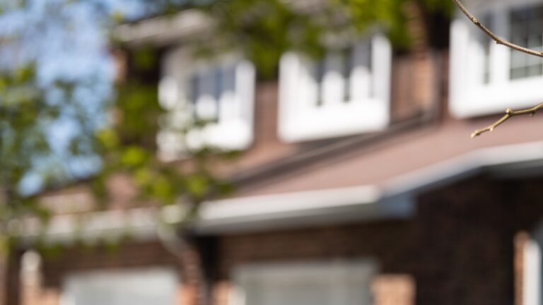 A real estate sign is posted outside a home in Pointe-Claire, a city in Montreal's West Island, Tuesday, May 7, 2024. (Christinne Muschi/The Canadian Press)