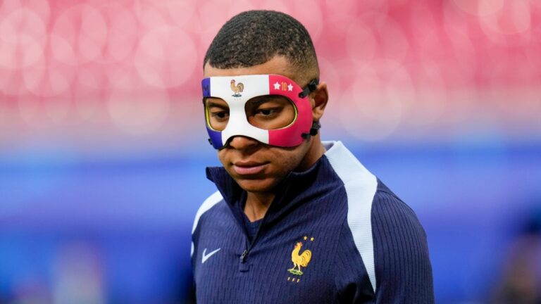 France's Kylian Mbappe wears a face mask as he runs during a training session in Leipzig, Germany, June 20, 2024. (AP Photo/Hassan Ammar)