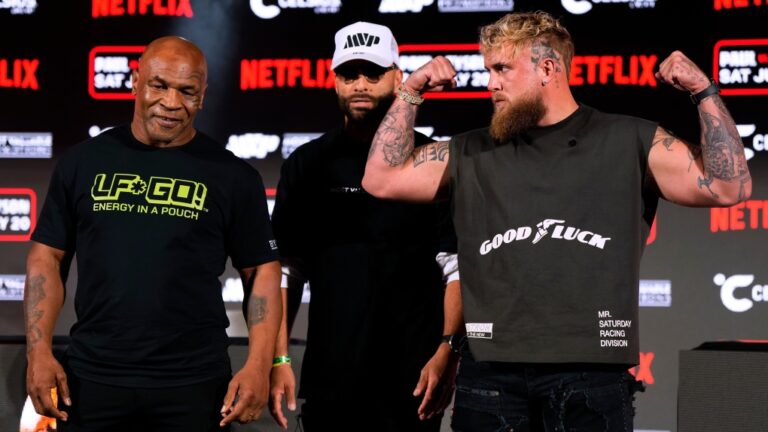 Mike Tyson, left, and Jake Paul, right, pose for photos during a news conference promoting their upcoming boxing bout, Thursday, May 16, 2024, in Arlington, Texas. The fight is schedule for July 20. (Sam Hodde / The Associated Press)