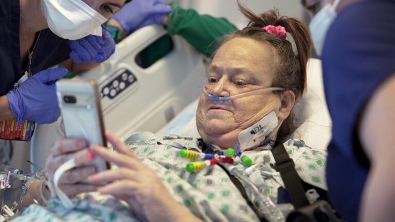 Lisa Pisano looks at photos of her dog after receiving a pig kidney transplant, at NYU Langone Health in New York, April 22, 2024. (Shelby Lum / AP Photo)