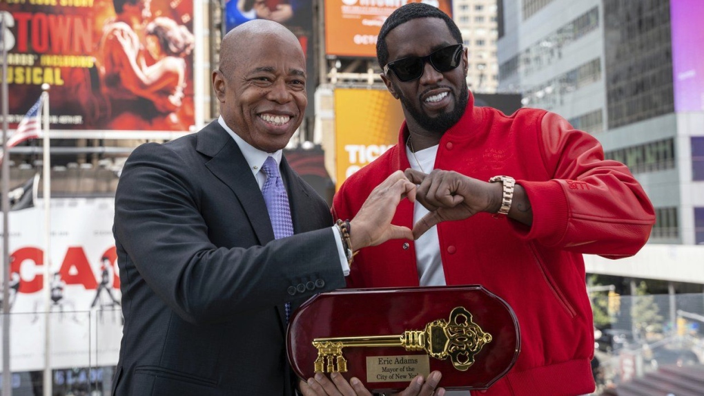 New York City Mayor Eric Adams, left, presenting the Key to the City to hip-hop artist Sean "Diddy" Combs in New York's Times Square, Friday, Sept. 15, 2023. (Caroline Rubinstein-Willis/AP Photo)