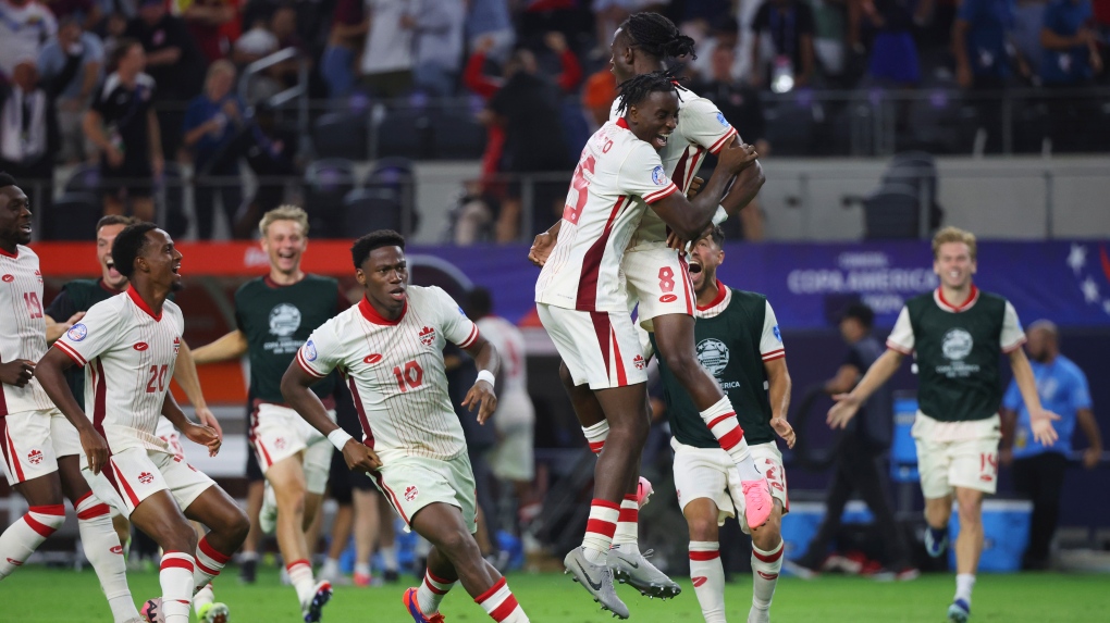 Canada midfielder Ismael Kone (8) celebrates with teammates after making the winning penalty kick against Venezuela a Copa America quarterfinal soccer match in Arlington, Texas, Friday, July 5, 2024. (AP Photo/Richard Rodriguez)