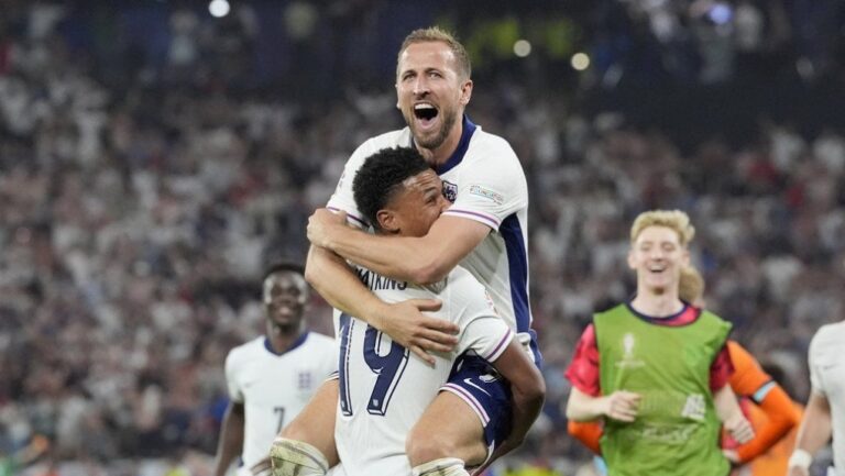 England's Harry Kane celebrates in the arms of teammate Ollie Watkins at the end of their semifinal match between the Netherlands and England at Euro 2024 in Dortmund, Germany, Wednesday, July 10, 2024. England won 2-1. (Martin Meissner/AP Photo)