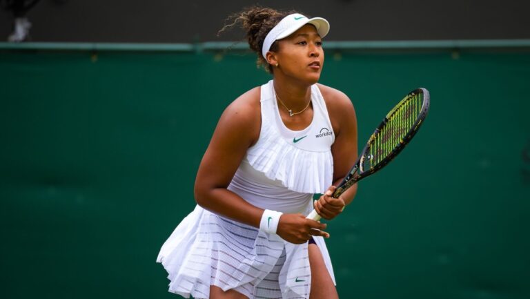 Naomi Osaka wore a flouncy take on the tennis dress at Wimbledon 2024, adhering to tournaments all-white, minimal logo rule — with an exception for dark-colored shorts, which is a new allowance for women. (Robert Prange / Getty Images via CNN Newsource)