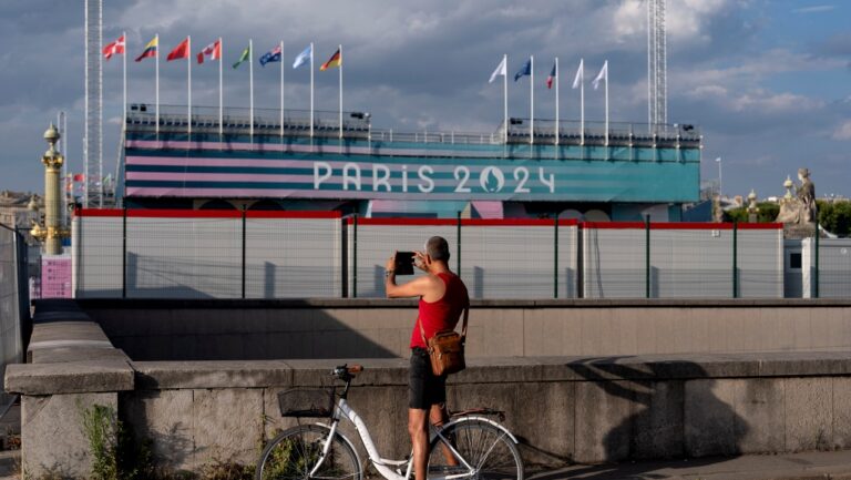 Workers operate along the Seine river at the 2024 Summer Olympics, Sunday, July 21, 2024, in Paris, France. (AP Photo/Thomas Padilla)