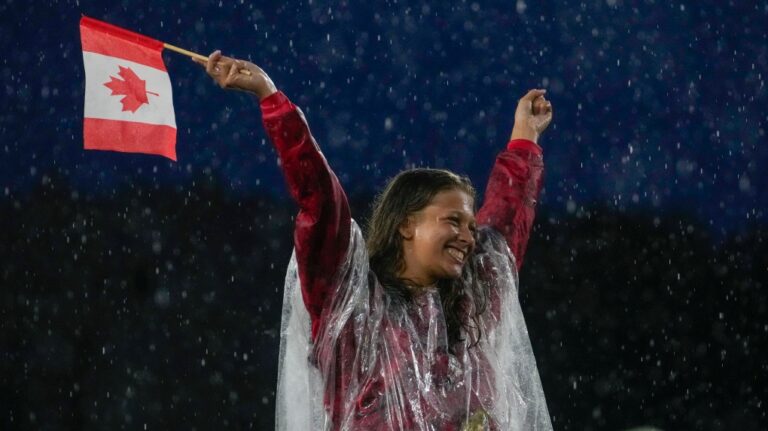 A Canadian athlete reacts while participating in the opening ceremony of the 2024 Summer Olympics, Friday, July 26, 2024, in Paris, France. (Andy Wong / AP Photo)