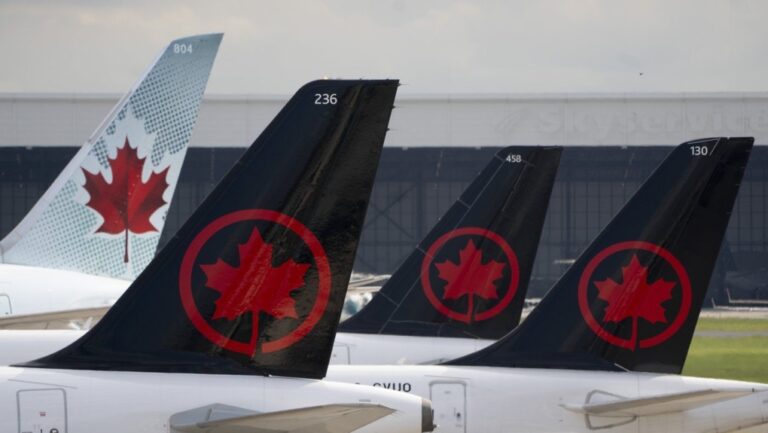 Air Canada logos are seen on the tails of planes at the airport in Montreal, Que., Monday, June 26, 2023. THE CANADIAN PRESS/Adrian Wyld