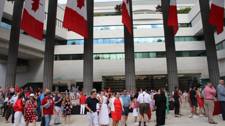 People dressed in red and white ate bacon and pancakes drenched in maple syrup at the Canada Day celebrations at the Embassy of Canada in Washington, D.C., Monday July 1, 2024. (The Canada Press/Kelly Geraldine Malone)