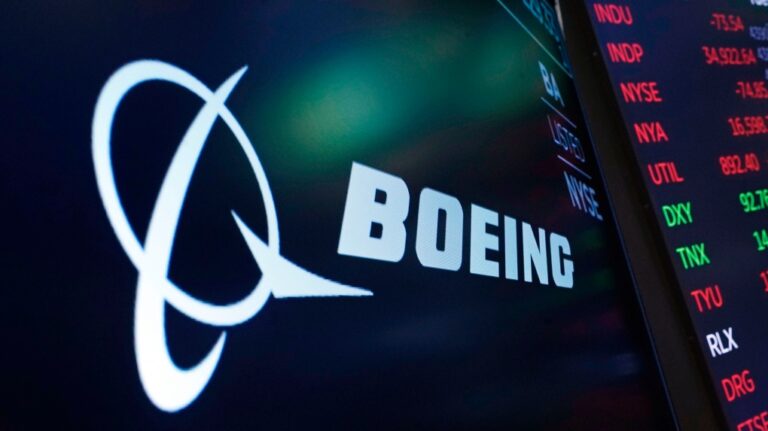 FILE - In this July 13, 2021, photo, the logo for Boeing appears on a screen above a trading post on the floor of the New York Stock Exchange. (AP Photo/Richard Drew, File)