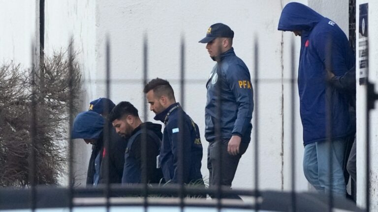 Police escort French rugby players Oscar Jegou, left, and Hugo Auradou, right, in Buenos Aires, Argentina, July 11, 2024. (AP Photo/Natacha Pisarenko)