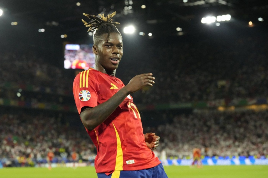 Spain's Nico Williams celebrates after scoring his side's 3rd goal against Georgia during a round of sixteen match at the Euro 2024 soccer tournament in Cologne, Germany, Sunday, June 30, 2024. (AP Photo/Frank Augstein)