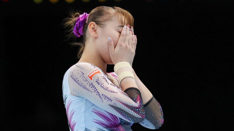 Japan's Shoko Miyata reacts after falling on the floor exercise during the women's team final at the Artistic Gymnastics World Championships in Antwerp, Belgium, Wednesday, Oct. 4, 2023. (AP Photo/Geert vanden Wijngaert)