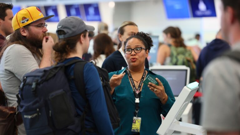 Delta staff help delayed travellers at Minneapolis/St. Paul International airport in Minneapolis on July. 19, 2024. (Adam Bettcher / AP Photo)
