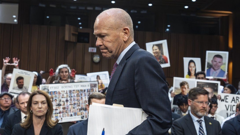 With protesters in the audience, Boeing CEO Dave Calhoun arrives to testify before a Senate subcommittee to answer to lawmakers about troubles at the aircraft manufacturer. (AP Photo/J. Scott Applewhite, File)