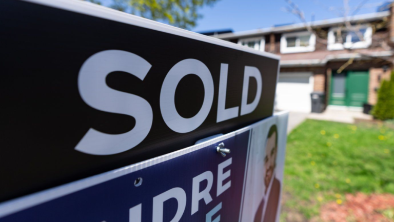 A real estate sign is posted outside a home in Montreal on Tuesday, May 7, 2024. THE CANADIAN PRESS/Christinne Muschi