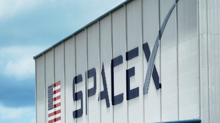 The SpaceX logo is displayed on a building, May 26, 2020, at the Kennedy Space Center in Cape Canaveral, Fla. (AP Photo/David J. Phillip, File)