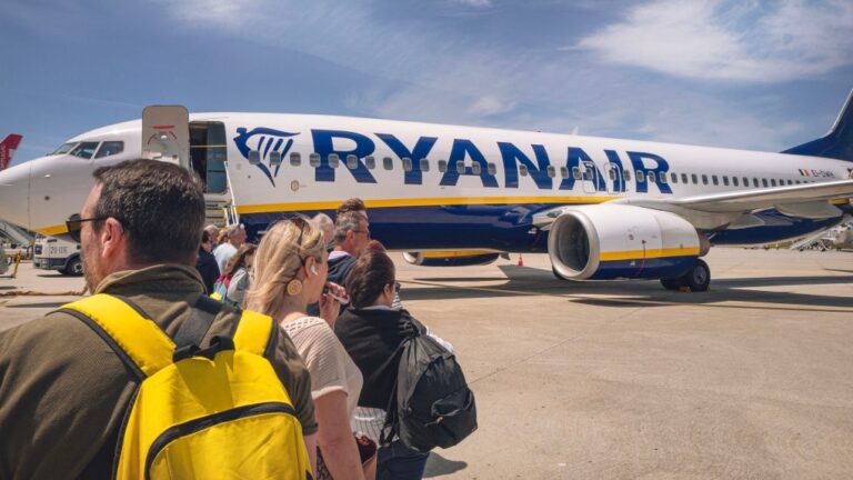 Ryanair reported a 46 per cent fall in profits in the first quarter of the year, and travelers are seen waiting to board a Ryanair flight to France at Porto airport, Portugal, in May.