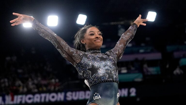 Simone Biles, of United States, smiles after competing on the vault during a women's artistic gymnastics qualification round at Bercy Arena at the 2024 Summer Olympics, Sunday, July 28, 2024, in Paris, France. (AP Photo/Charlie Riedel)
