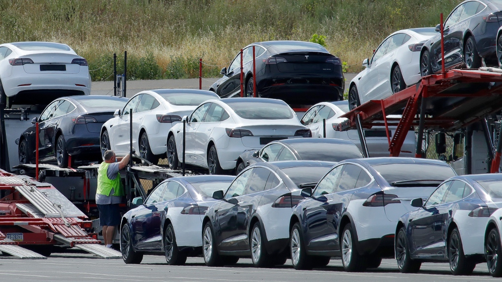 FILE - Tesla cars are loaded onto carriers at the Tesla electric car plant on May 13, 2020, in Fremont, Calif. (AP Photo/Ben Margot, File)