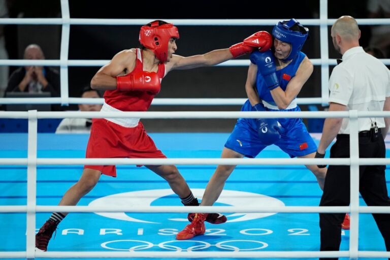 Algeria's Imane Khelif, left, fights China's Yang Liu in their women's 66 kg final boxing match at the 2024 Summer Olympics, Friday, Aug. 9, 2024, in Paris, France. (AP Photo/John Locher)