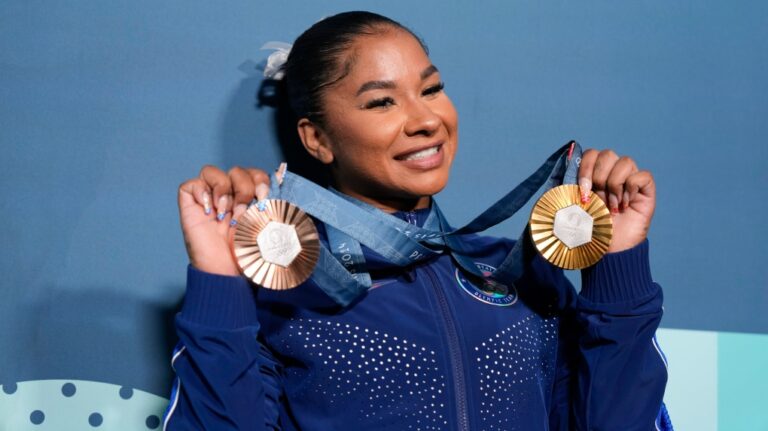 Jordan Chiles, of the United States, holds up her medals after the women's artistic gymnastics individual apparatus finals Bercy Arena at the 2024 Summer Olympics, Monday, Aug. 5, 2024, in Paris, France. (Charlie Riedel / AP Photo)