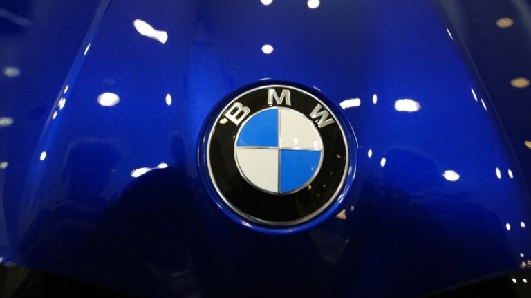 The company logo shines on the hood of an unsold vehicle at a Mini Honda BMW dealership on July 22, 2024, in Highlands Ranch, Colo. (AP Photo/David Zalubowski, File)