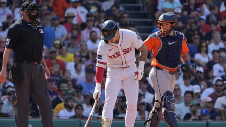 Boston Red Sox's Jarren Duran puts his bat down beside Houston Astros catcher Yainer Diaz after taking a walk during the sixth inning of a baseball game, Sunday, Aug. 11, 2024, in Boston. (Michael Dwyer/AP Photo)