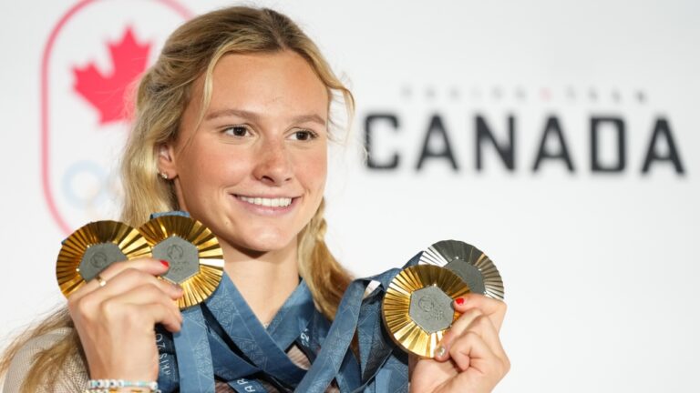 Canada's Summer McIntosh poses with her four medals won in the pool at the 2024 Summer Olympics, Monday, Aug. 5, 2024 in Paris, France.  THE CANADIAN PRESS/Christinne Muschi
