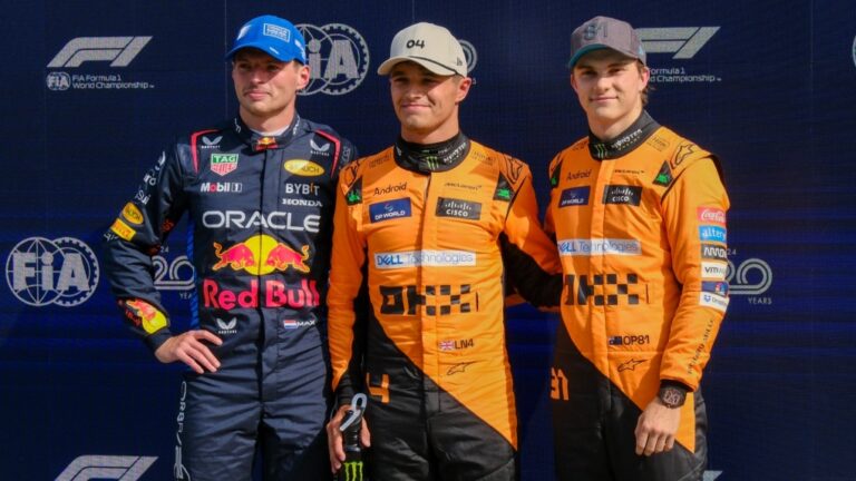 McLaren driver Lando Norris of Britain, centre, celebrates his pole position with second placed Red Bull driver Max Verstappen of the Netherlands, left, and third McLaren driver Oscar Piastri of Australia after qualifying session ahead of the Formula One Dutch Grand Prix race at the Zandvoort racetrack, Netherlands, Aug. 24, 2024. (AP Photo/Patrick Post)
