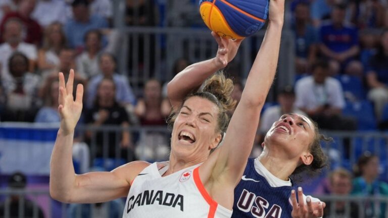Canada's Michelle Plouffe (1) is fouled by United States Dearica Hamby (5) during the women's 3 X 3 basketball bronze medal game at the Summer Olympics in Paris on Monday, Aug. 5, 2024. (THE CANADIAN PRESS/Adrian Wyld)