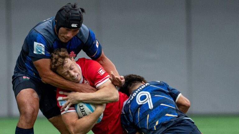 Canada's Jason Higgins is stopped by Japan's Shogo Miura, left, and Shinobu Fujiwara, right, during the first half of Pacific Nations Cup rugby, in Vancouver, on Sunday, August. 25, 2024. THE CANADIAN PRESS/Ethan Cairns