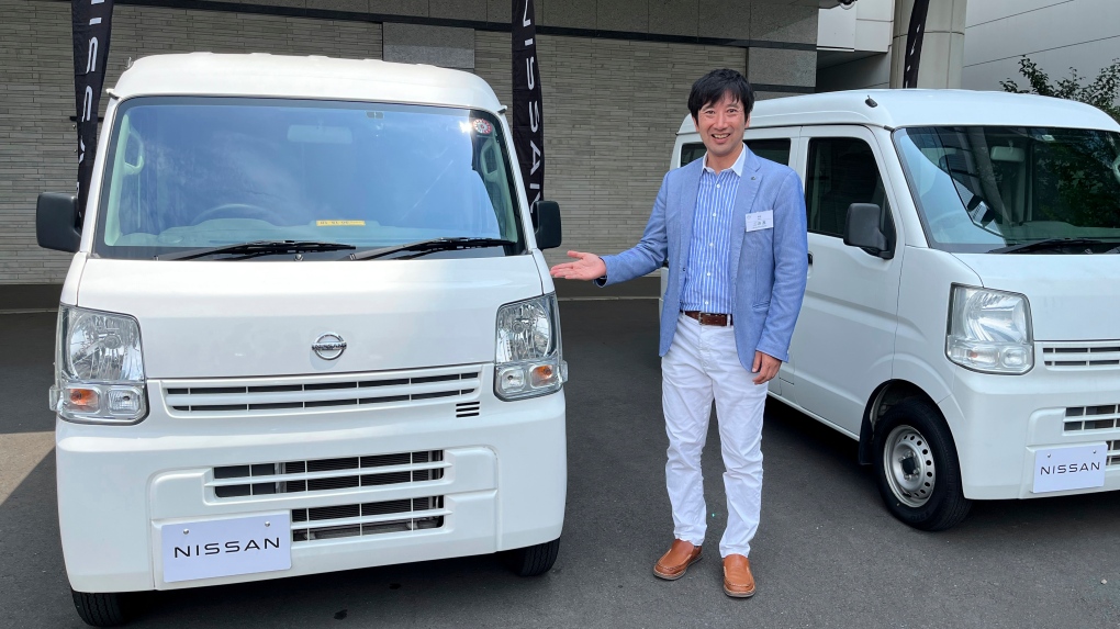 Susumu Miura, a Nissan Research Center manager, shows a Nissan car that is coated with the special "cool paint," under testing at Tokyo’s Haneda airport Tuesday, Aug. 6, 2024. (AP Photo/Yuri Kageyama)