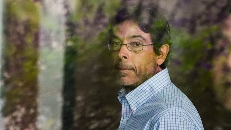 Dr. Mark Chavez, a physician from San Diego, who is charged in connection with actor Matthew Perry's death from an accidental ketamine overdose, is seen through a glass window as he arrives at the Roybal Federal Courthouse in Los Angeles, Aug. 30, 2024. (AP Photo/Damian Dovarganes)