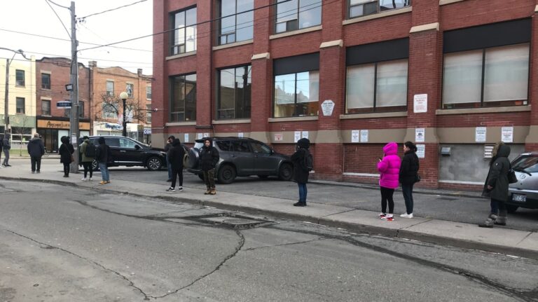 People line up outside a Service Canada to file for employment insurance amid the COVID-19 pandemic. (Craig Wadman/CTV News Toronto)