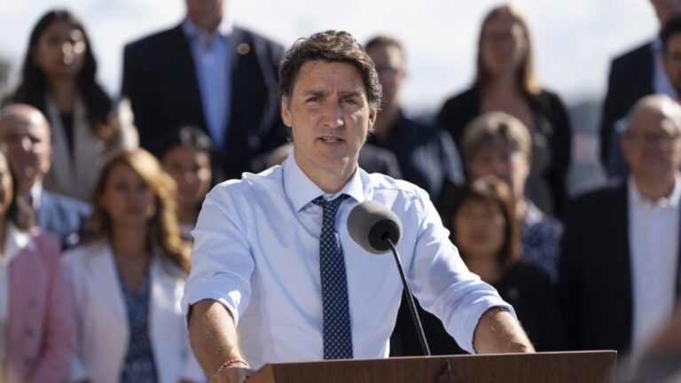 Prime Minister Justin Trudeau speaks to reporters as cabinet members look on during the Liberal cabinet retreat in Charlottetown, P.E.I. on Wednesday, August 23, 2023. THE CANADIAN PRESS/Darren Calabrese