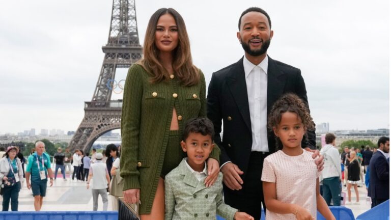 (From left) Chrissy Teigen, John Legend and their children, Miles and Luna are pictured at the opening ceremony of the 2024 Summer Olympics in Paris. (Natacha Pisarenko/AP via CNN Newsource)